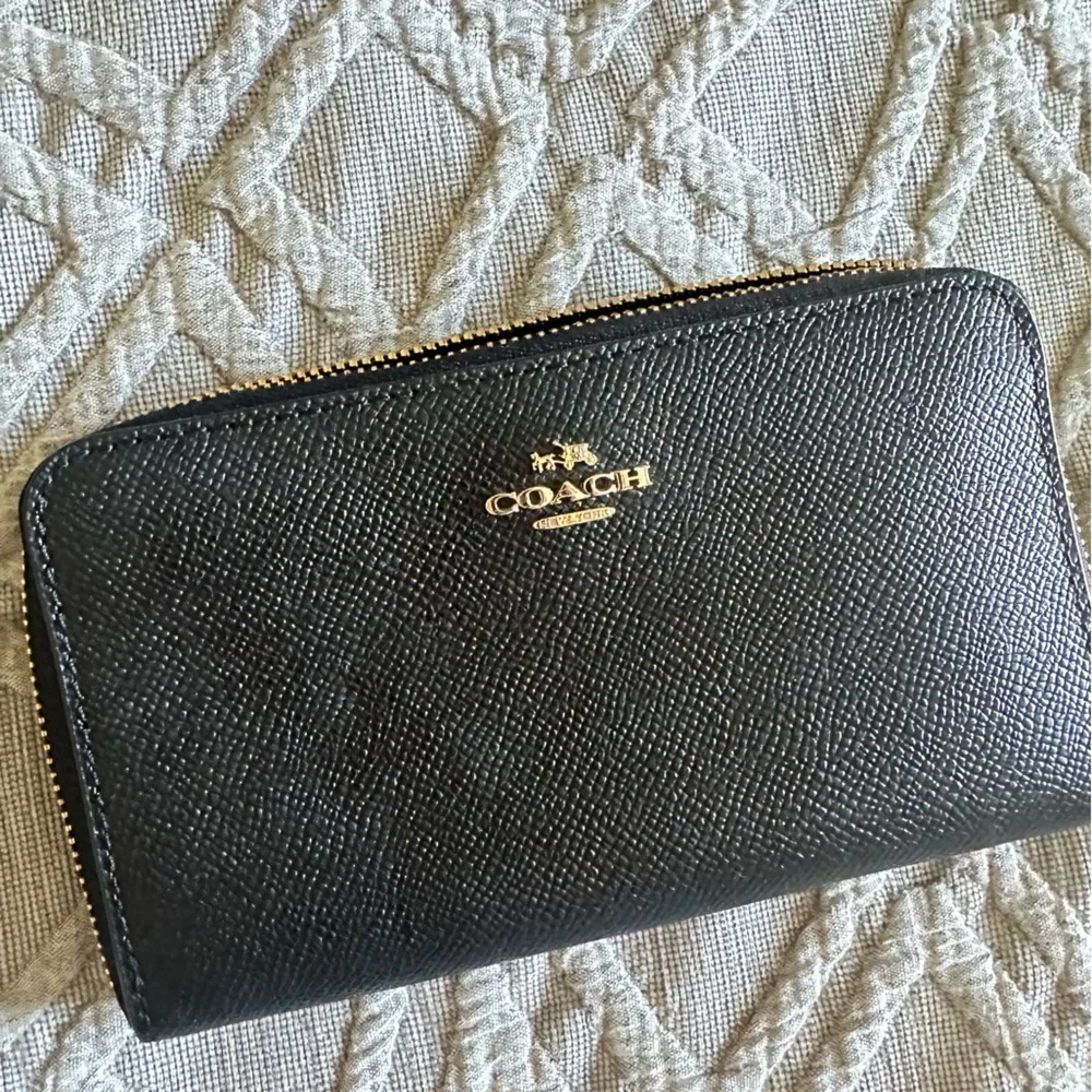 Coach wristlet zip around black pebble wallet